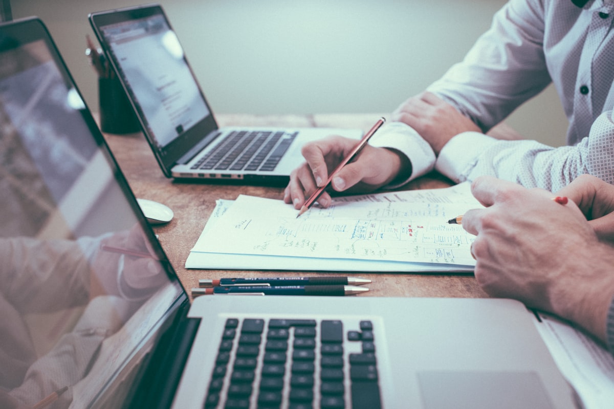 Real estate professional setting up CRM workflow automation on a laptop with data charts